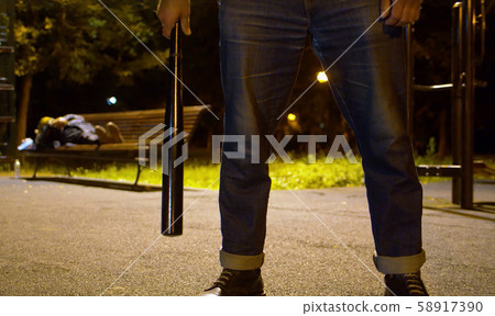 Hands of criminal with a baseball bat 58917390