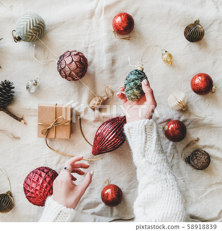 Christmas toys and woman's hands with pine cone Christmas toys and woman's hands with pine cone 58918839