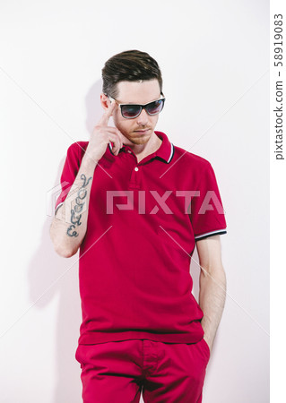 Handsome man wearing styled sunglasses and marsala clothes, shirt, jeans. on White. Direct trendy 58919083