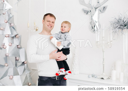 Lovely father keeping son on hands, hugging and 58919354