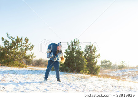 Loving couple play in the winter in the forest. 58919929