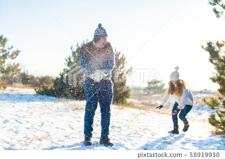 Loving couple play snowballs in winter in the Loving couple play snowballs in winter in the 58919930