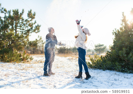Loving couple play snowballs in winter in the 58919931