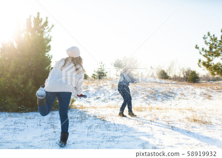 Loving couple play snowballs in winter in the Loving couple play snowballs in winter in the 58919932