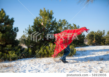 winter walk in the forest. A guy in a red plaid 58919936