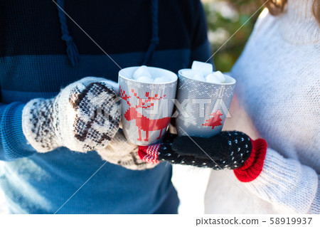 Close-up of a couple holding cups with deers with Close-up of a couple holding cups with deers with 58919937