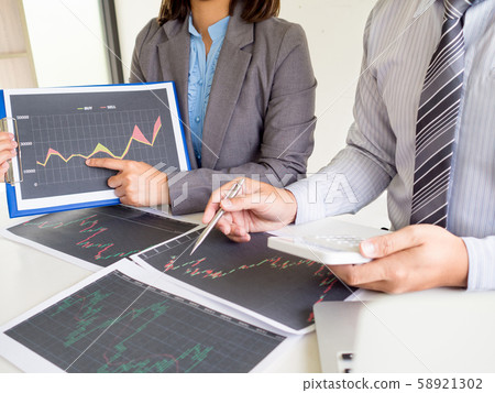 Businessman and businesswomen discussion and analyze stock graph report, set targets for online trading management success Businessman and businesswomen discussion and analyze stock graph report, set targets for online trading management success 58921302