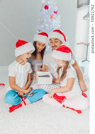 Christmas Family Opening Present Gift box. Christmas time Christmas Family Opening Present Gift box. Christmas time 58921762