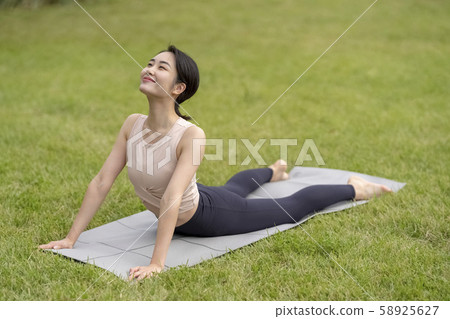 瑜伽在草地公園放鬆(眼鏡蛇式)如果您上床睡覺前可以改善睡眠質量 瑜伽在草地公園放鬆(眼鏡蛇式)如果您上床睡覺前可以改善睡眠質量 58925627