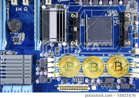 Golden Bitcoin token currency mining concept on a computer motherboard Golden Bitcoin token currency mining concept on a computer motherboard 58925876