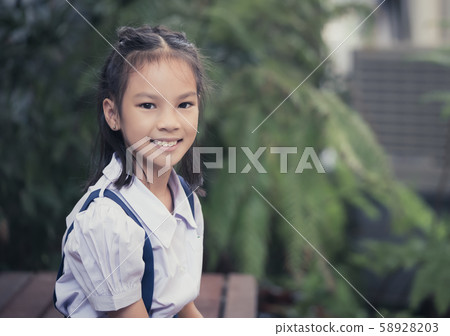 Portrait of Happy Thai student girl sitting in Portrait of Happy Thai student girl sitting in 58928203