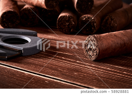 Still life with cuban cigars and cutter on old Still life with cuban cigars and cutter on old 58928881