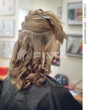 Woman with curly hair sitting Woman with curly hair sitting 58929017