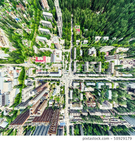 Aerial city view with crossroads and roads, houses, buildings, parks and parking lots. Sunny summer 58929179