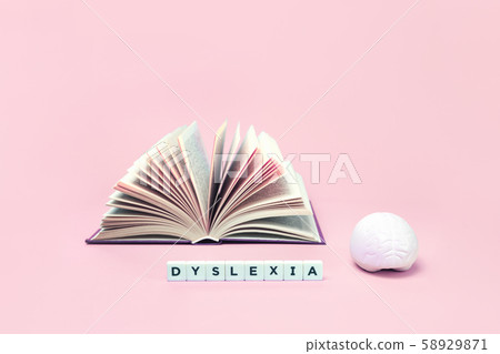 Dyslexia word book and brain on pink with copy 58929871