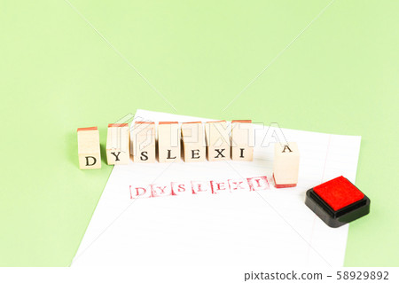 Dyslexia word stamped on notebook page on green Dyslexia word stamped on notebook page on green 58929892