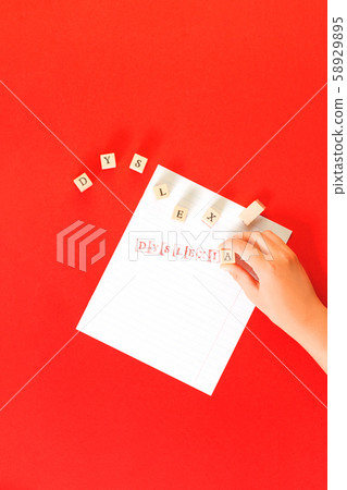 Dyslexia word stamped on notebook page on red 58929895