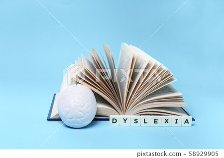 Dyslexia word book and brain on blue with copy Dyslexia word book and brain on blue with copy 58929905