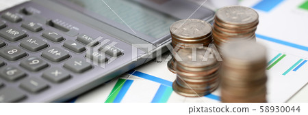 Silver calculator with gray keyboard is lying Silver calculator with gray keyboard is lying 58930044