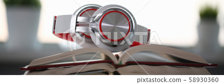 Headphones are on the table in the office Headphones are on the table in the office 58930360