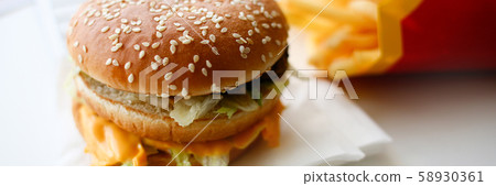 Hamburger and french fries with headphones 58930361