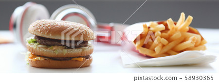 Hamburger and french fries with headphones 58930365
