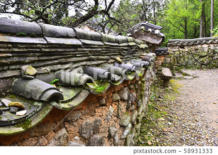 Vintage scenery with old basin and stone wall 58931333
