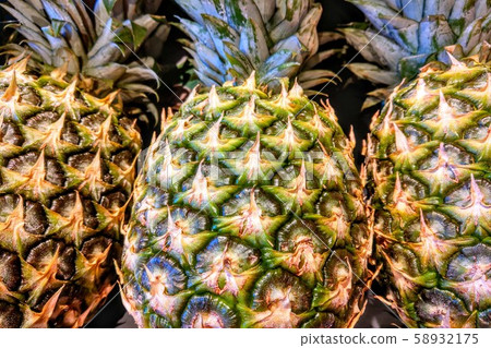 Close-up on pineapples at the grocery store on the counter, fruit. Close-up on pineapples at the grocery store on the counter, fruit. 58932175