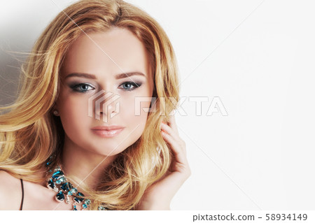 Woman with blonde curly hair and necklace Woman with blonde curly hair and necklace 58934149