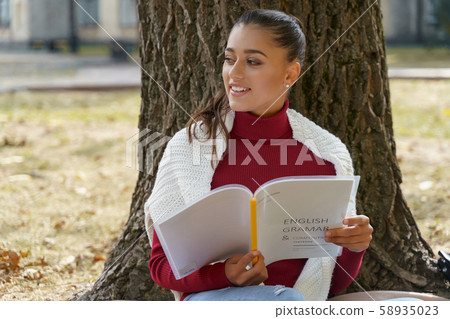 Happy student trying to remember the grammar rule Happy student trying to remember the grammar rule 58935023