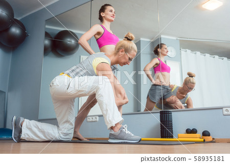 Woman in the physical therapy stretching her knee 58935181