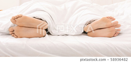 Married couple ignoring each other, lying back to back in bed 58936482