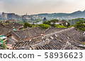 Hanok roof and Gyeongbokgung Palace and city view in the distance 58936623