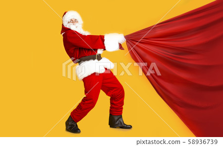 Santa Claus pulling unnormous sack with Cristmas presents Santa Claus pulling unnormous sack with Cristmas presents 58936739