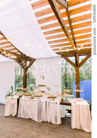 Wedding stand-up meal. Snack for guests. Celebration. Wedding buffet in restaurant outdoors, wooden 58936800
