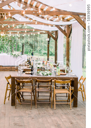 Wedding tables in restaurant outdoors. Banquet. The chairs and table for guests, decorated with 58936995