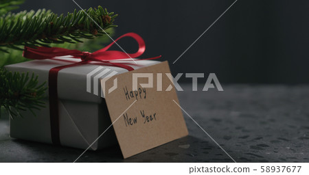 happy new year paper card next to gift box happy new year paper card next to gift box 58937677