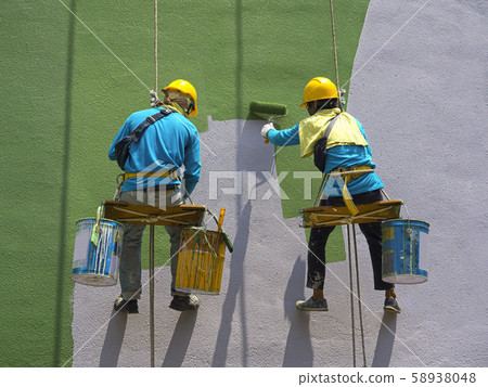 Painters painting exterior of building 58938048