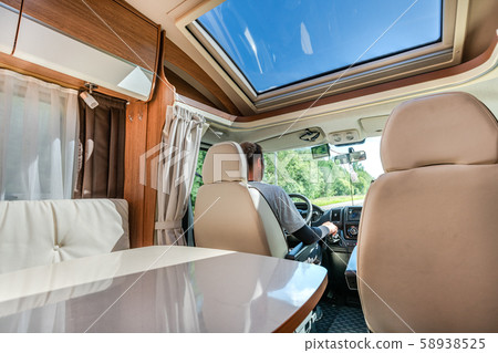 Man driving on a road in the Camper Van RV 58938525