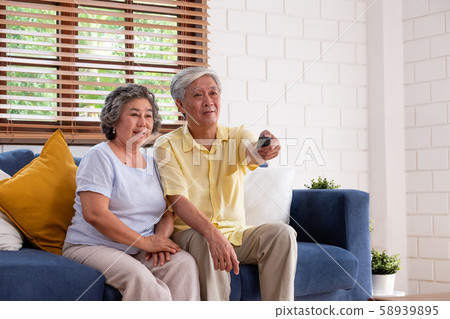 Asian couple senior sitting on sofa Asian couple senior sitting on sofa 58939895