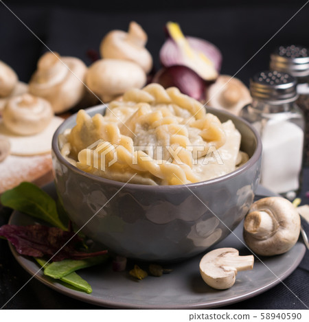 vareniki and ingredients on a black background 58940590