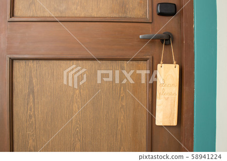 Please clean room message on wooden label hanging on door knob. Please clean room message on wooden label hanging on door knob. 58941224