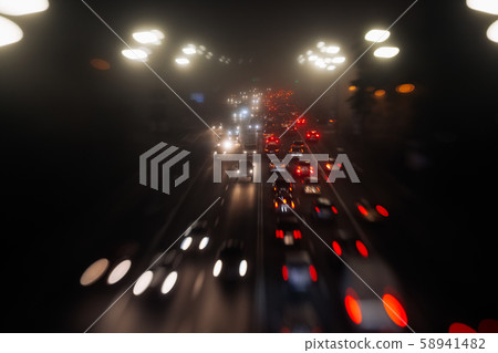 Busy traffic in city fog blur lights of cars on road Busy traffic in city fog blur lights of cars on road 58941482