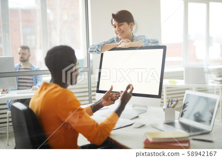 Smiling Colleagues Chatting in Office Smiling Colleagues Chatting in Office 58942167