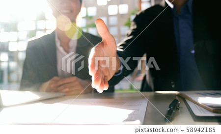 Businessmans handshake after good deal. 58942185