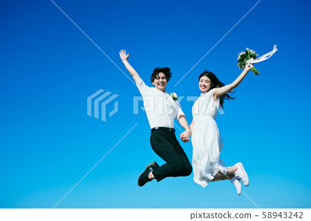 Wedding jump blue sky 58943242
