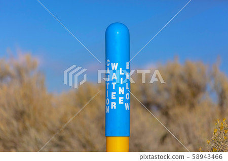 Water Line Below sign on a blue pole yellow base 58943466