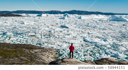 Travel in arctic landscape nature with icebergs - Greenland tourist man explorer Travel in arctic landscape nature with icebergs - Greenland tourist man explorer 58944151