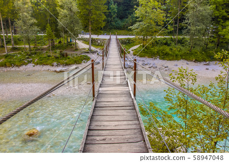 Swingbridge over blue Soca river near Bovec Swingbridge over blue Soca river near Bovec 58947048