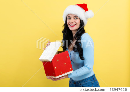 Young woman opening a Christmas gift box 58947626